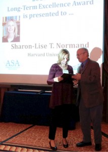Sharon-Lise Normand receives one of two Long-Term Excellence Awards from Alan Zaslavsky, who was the previous awardee.