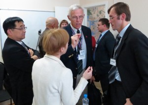 ASA delegates Youngjo Lee (left) and John Boyer (center) engage in conversation with Artem Egorov (right) and a Russian interpreter at the Center for Statistical Techniques in St. Petersburg, Russia.