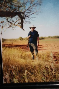 Clyde Martin stands in a field in what looks like Africa, but is really Lubbock, Texas.