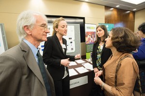 SAMSI Director Richard Smith talks with NSF Director France Cordova while Jessi Cisewski of Carnegie Mellon University and SAMSI postdoc Kimberly Kaufeld discuss their poster with attendees.(Photo provided by Scavone Photography)