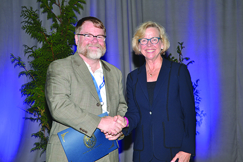 Patrick Ball accepts the Peace Award from ASA President Lisa LaVange during this year’s awards ceremony during the 2018 Joint Statistical Meetings in Vancouver, Canada. 
