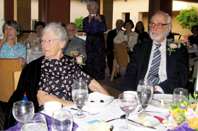 Ted Anderson and his wife, Dorothy, listen to a speaker during the conference banquet.