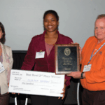 Cavell Brownie Scholar Sydeaka Watson (center) receives her Stat Bowl second-place award from Stephanie Cano and Mike Anderson.