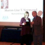 Sharon-Lise Normand receives one of two Long-Term Excellence Awards from Alan Zaslavsky, who was the previous awardee.
