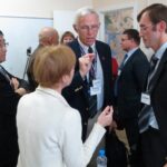 ASA delegates Youngjo Lee (left) and John Boyer (center) engage in conversation with Artem Egorov (right) and a Russian interpreter at the Center for Statistical Techniques in St. Petersburg, Russia.