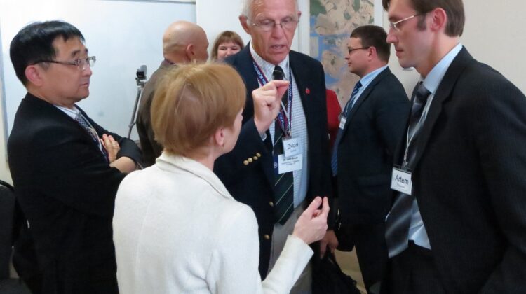 ASA delegates Youngjo Lee (left) and John Boyer (center) engage in conversation with Artem Egorov (right) and a Russian interpreter at the Center for Statistical Techniques in St. Petersburg, Russia.
