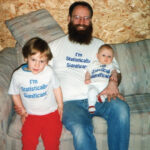 Ronald P. Barry with his children, Eli Barry-Garland (left) and Maura Barry-Garland (right). The picture was published in the Marketplace in Amstat News sometime between 1994–1996.