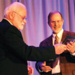 Karl Peace (left) accepts the Sellers-McCroan Award, presented by Wade Sellers.