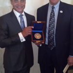 Hugo Blackwell (David Blackwell’s son) displays David Blackwell’s National Medal of Science with ASA Past President Nathaniel Schenker.