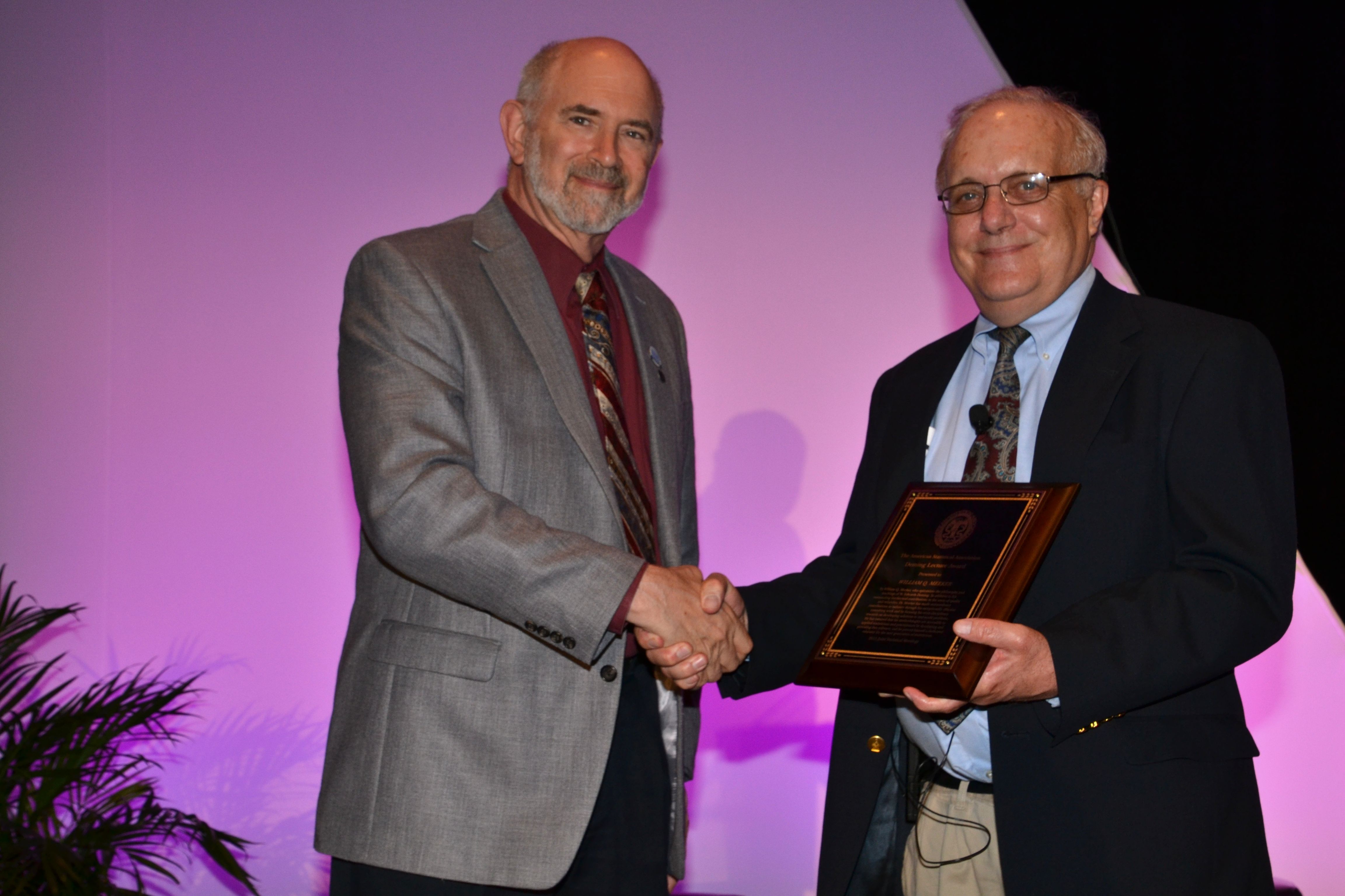 ASA Preisdent David Morganstein presents William Meeker with the Deming Lecture plaque.