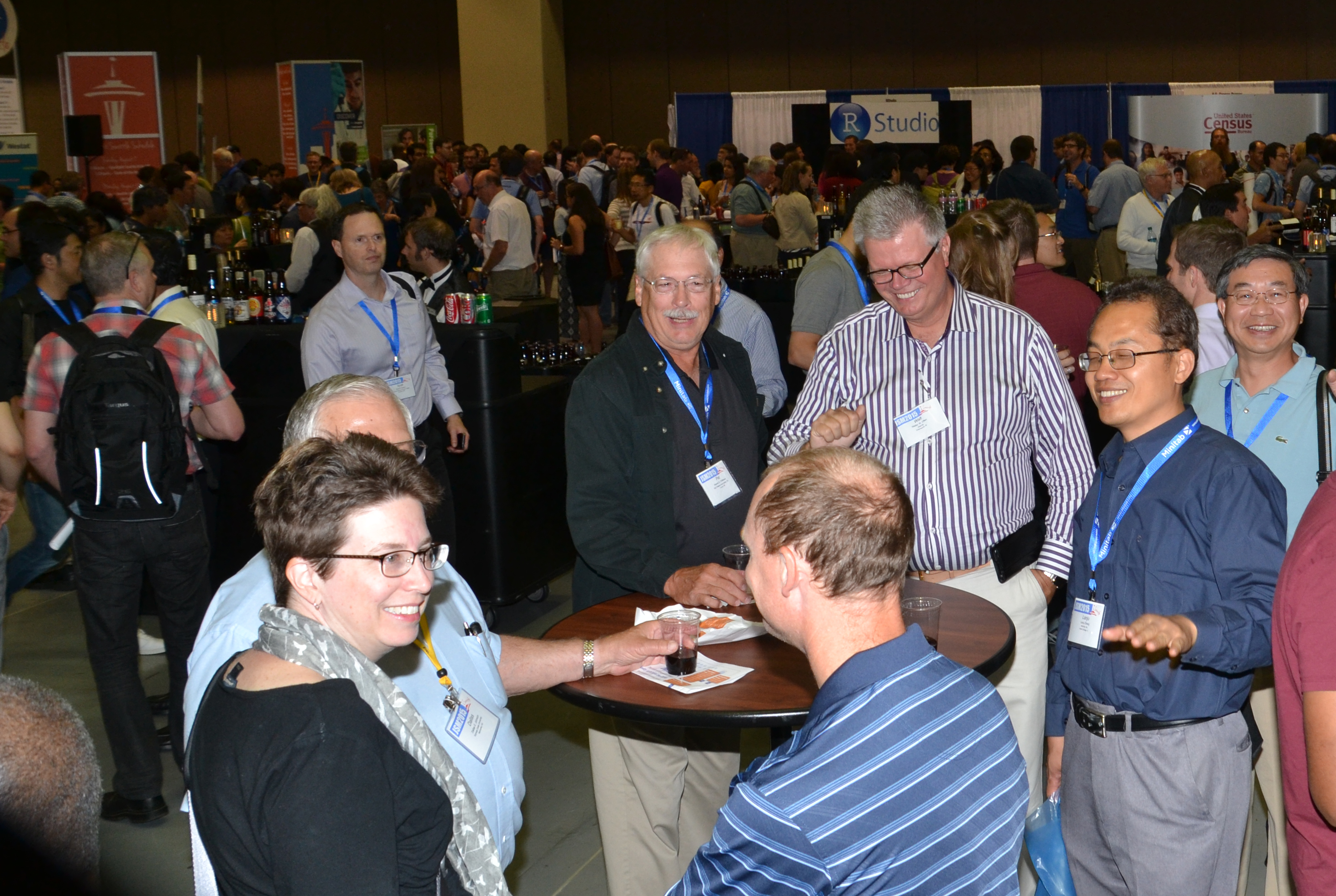 Attendees enjoy free food and drink at the Opening Mixer, which took place in the exhibit hall. 