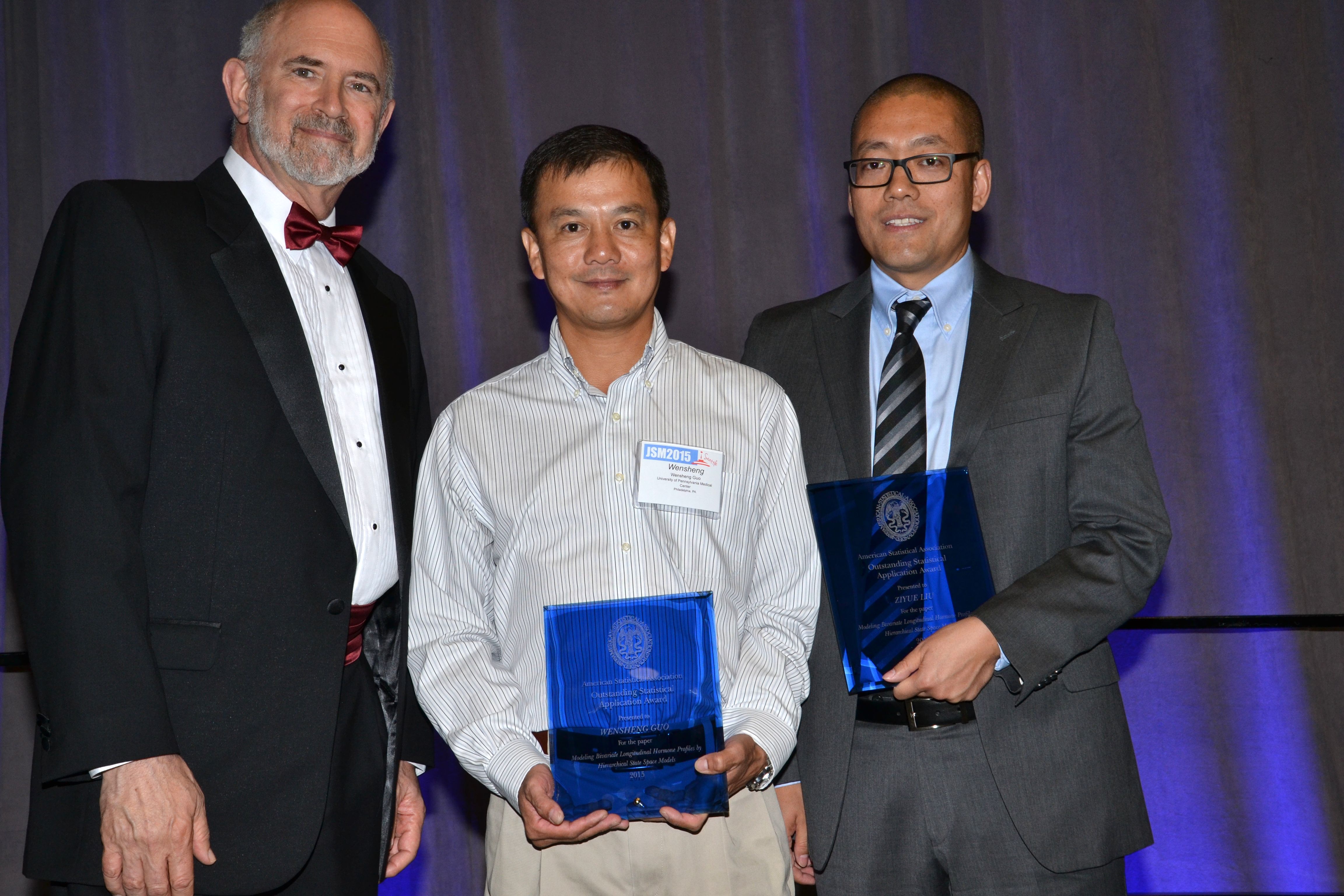 ASA President David Morganstein presents the Award of Outstanding Statistical Application to Wensheng Guo of the University of Pennsylvania and Ziyue Liu of Indiana University.
