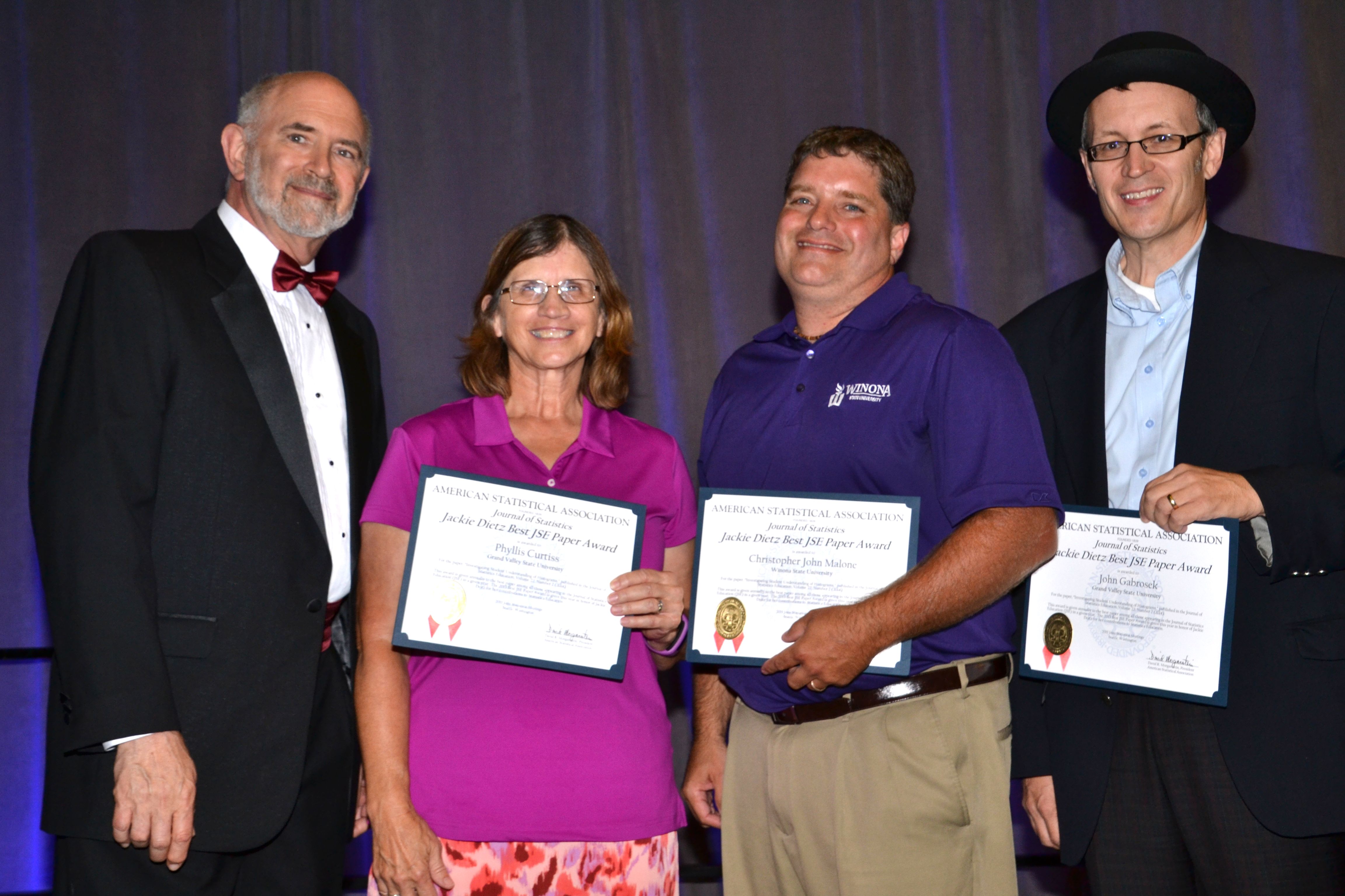 ASA President David Morganstein with the winners of the Jackie Dietz Best <em>Journal of Statistics Education</em> Paper Award: Phyllis Curtiss of Grand Valley State University, Christopher John Malone of Winona State University, and John Gabrosek of Grand Valley State University