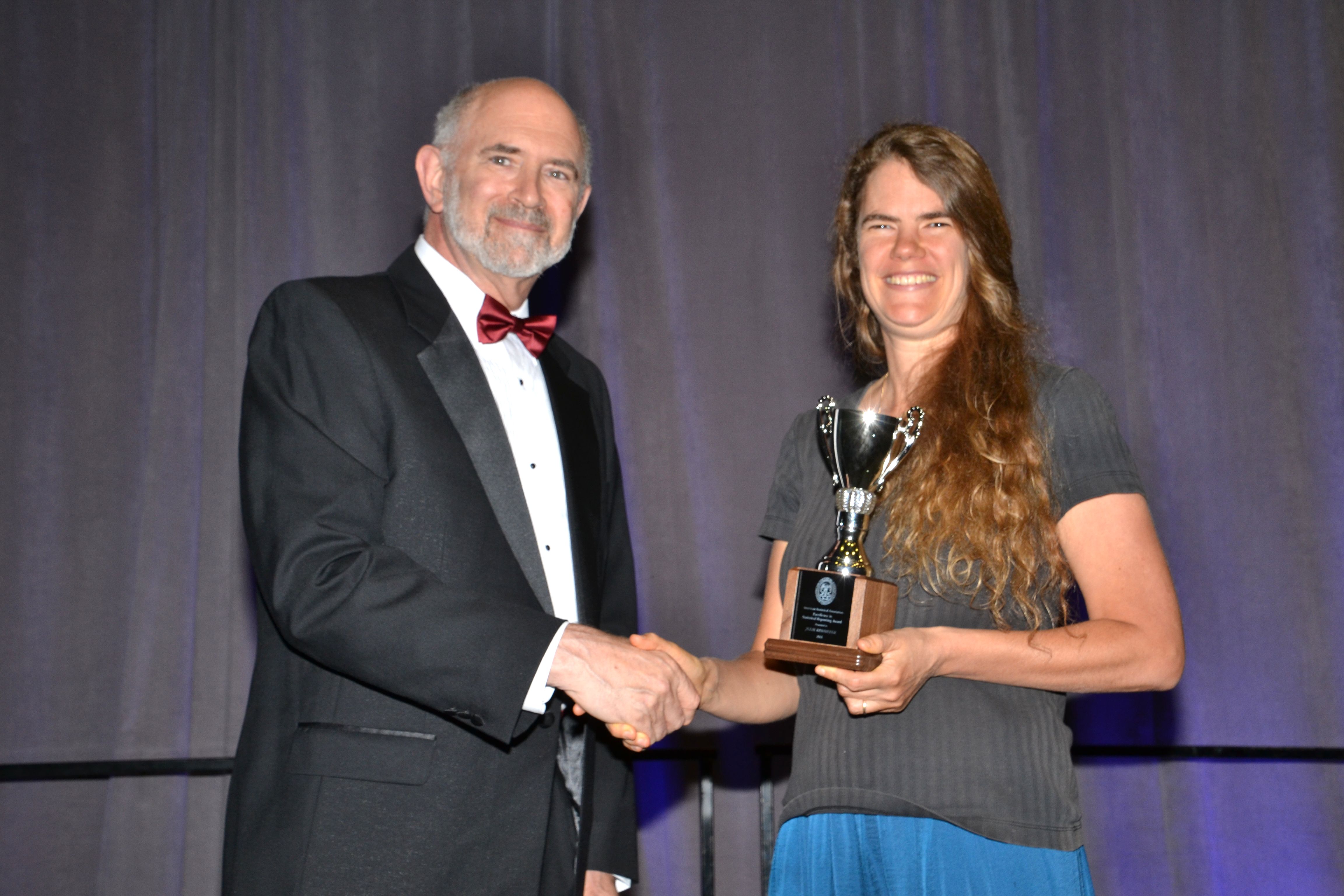 Freelance math and science writer Julie Rehmeyer receives the Excellence in Statistical Reporting Award from ASA President David Morganstein.