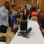 Conference participants surround Adrian Coles, a statistical research scientist at Duke Clinical Research Institute, during StatFest.