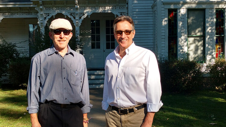 Terry Katz (wearing hat) stands next to Clifton Truman Daniel, the oldest grandson of President Harry Truman, in front of the Truman home in Independence, Missouri.