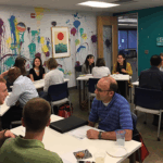 Gabe Farkas (right) chats with two students during the speed mentoring program.