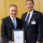 John Bailer, right, president-elect of the International Statistical Institute, presents Andreas Georgiou with a commendation for upholding the highest professional standards in his public service.