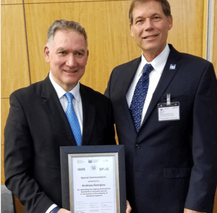 John Bailer, right, president-elect of the International Statistical Institute, presents Andreas Georgiou with a commendation for upholding the highest professional standards in his public service.