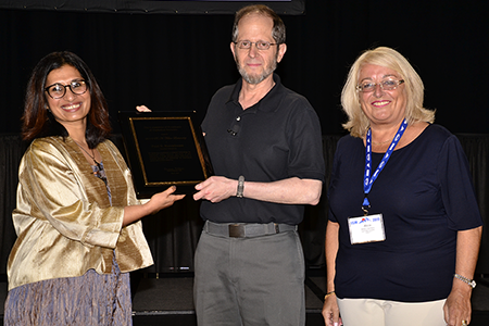 Bhramar Mukherjee (left) and Alicia Carriquiry, present Paul R. Rosenbaum (University of Pennsylvania) with the Fisher Lectureship award