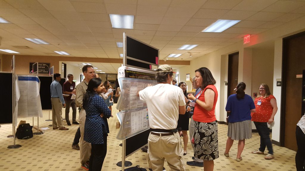Participants mingle during the poster session.