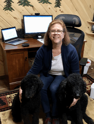 Photo of Allison Florance works remotely during the COVID-19 pandemic with her two helpers, Dudley and Bullwinkle.