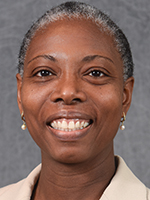 A headshot of a black woman with short salt-and-pepper hair smiles.