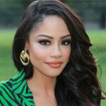 Andrea Roberson Photo. Long hair, large earrings, big eyelashes.