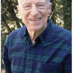 Photo of Jabine from 2008, wearing dark plaid flannel button down shirt
