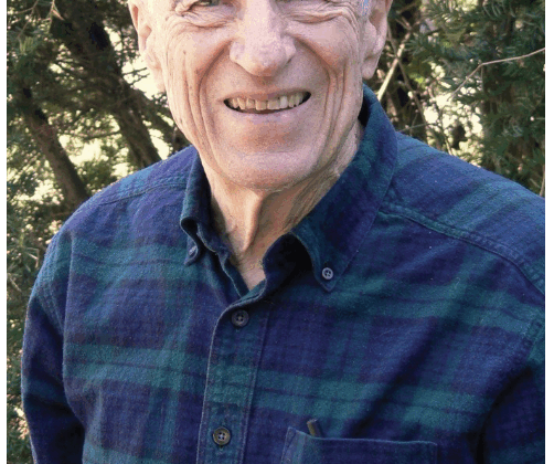 Photo of Jabine from 2008, wearing dark plaid flannel button down shirt