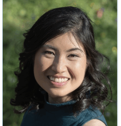 Po-Ling Louh, big smile, dark hair, background of photo is outdoors.