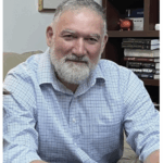 Photo of Andreas Georgio, sitting in office and looking relaxed, beard, mustache