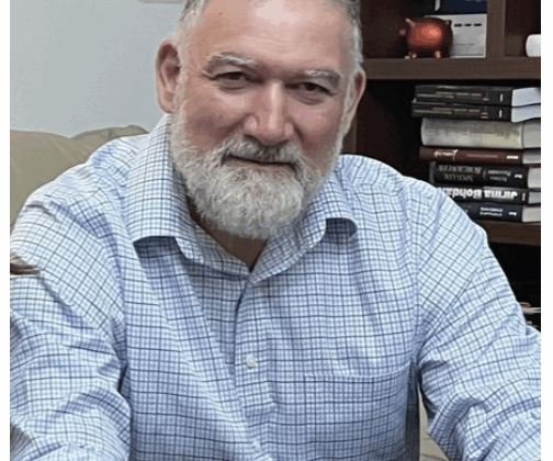 Photo of Andreas Georgio, sitting in office and looking relaxed, beard, mustache