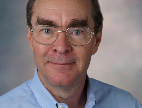 Photo of David Banks, glasses, slight smile, large eyebrows