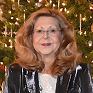 Portrait of Brenda Gaydos, a white woman with long blond hair and a slight smile