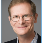 White man, glasses, big smile