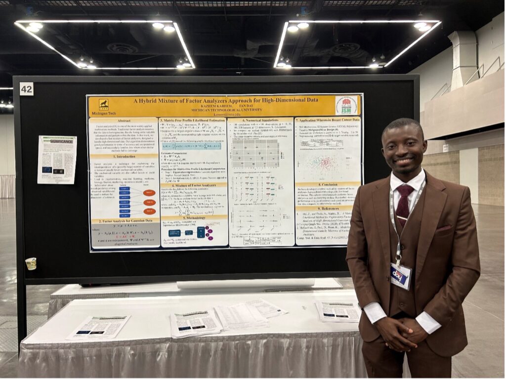 Kazeem Kareem, a young Black man, stands in front of his winning poster