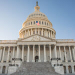 The Capitol Building in Washington, D.C. with bright blue sky.