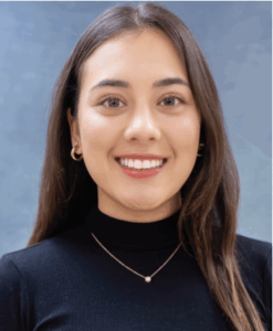 Portrait of Bandov, female, big smile, long hair, turtleneck
