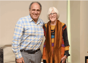 Photo of Tibshirani --gray hair, balding--with arm around Donna Brogan--white, short hair, glasses-- both have warm smiles.