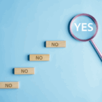 Magnifying glass shows the word YES really big, under it is five blocks that say no
