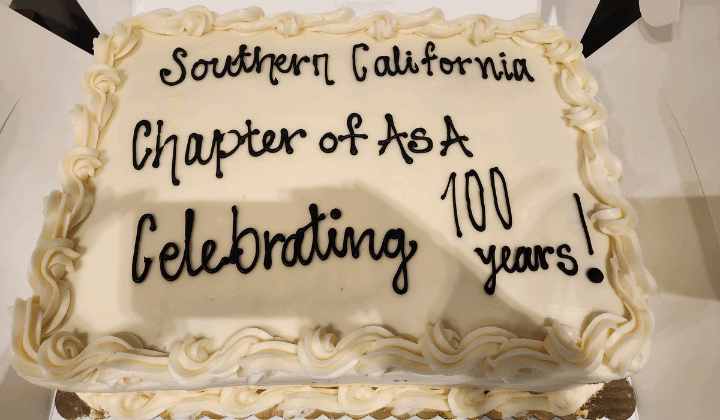 A white-frosted cake reading "Souther California Chapter of ASA Celebrating 100 years!