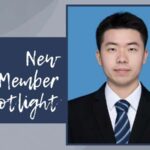 The words New Member Spotlight appear next to a photo of an Asian man in a suit and tie.