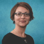 Aleksandra Slavkovic short hair, glasses, slight smile