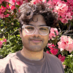 Glasses, short hair, t-shirt, flowered background