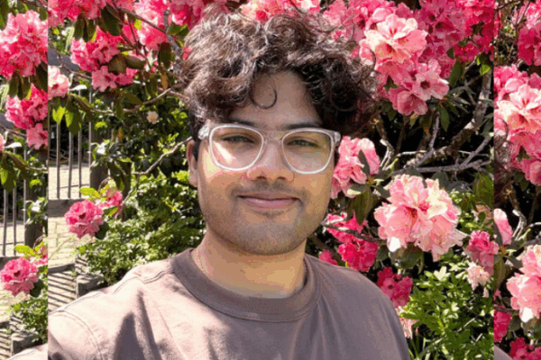 Glasses, short hair, t-shirt, flowered background