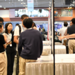 People look at posters at a conference