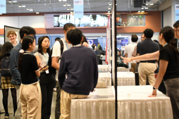 People look at posters at a conference