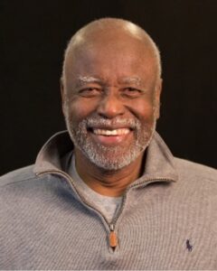 Bill Carter Jenkins, smiling in a zip-up sweater.