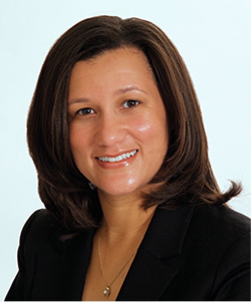 Dionne Price, smiling in a black jacket and shoulder-length dark brown hair.